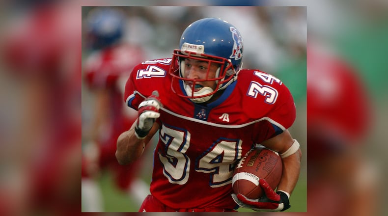 Lyle Garrison, of Carroll, runs the ball in the first quarter as they hosted Chaminade-Julienne during the 2004 season. RON ALVEY / STAFF
