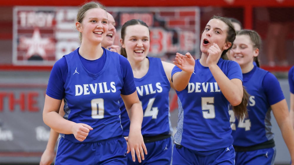 Brookville sophomore guard Jolie Gudorf (left) celebrates with Haley Crabtree after the Blue Devils beat Cincinnati Hills Christian Academy 52-40 in a Division IV district final on Saturday, Feb. 28 at Troy High School's Trojan Activities Center. BRYANT BILLING / STAFF