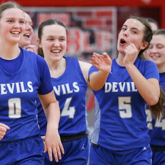 Brookville sophomore guard Jolie Gudorf (left) celebrates with Haley Crabtree after the Blue Devils beat Cincinnati Hills Christian Academy 52-40 in a Division IV district final on Saturday, Feb. 28 at Troy High School's Trojan Activities Center. BRYANT BILLING / STAFF