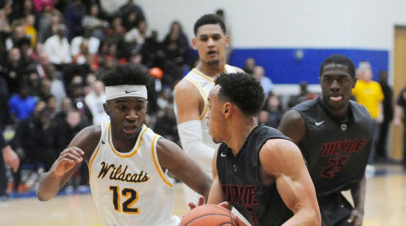 Larry Stephens of Springfield (left) and Darius Quisenberry of Wayne. The GWOC National East teams split in the regular season and both have advanced to D-I district finals. MARC PENDLETON / STAFF