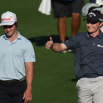 Blades Brown, right, reacts for a cheering gallery as he walks with David Ford as the gallery cheers for Brown who finished with a 12-under-par 60 during the second round of the American Express golf event at the Jack Nicklaus Tournament Course at PGA West Friday, Jan. 23, 2026, in La Quinta, Calif. (AP Photo/Ross D. Franklin)