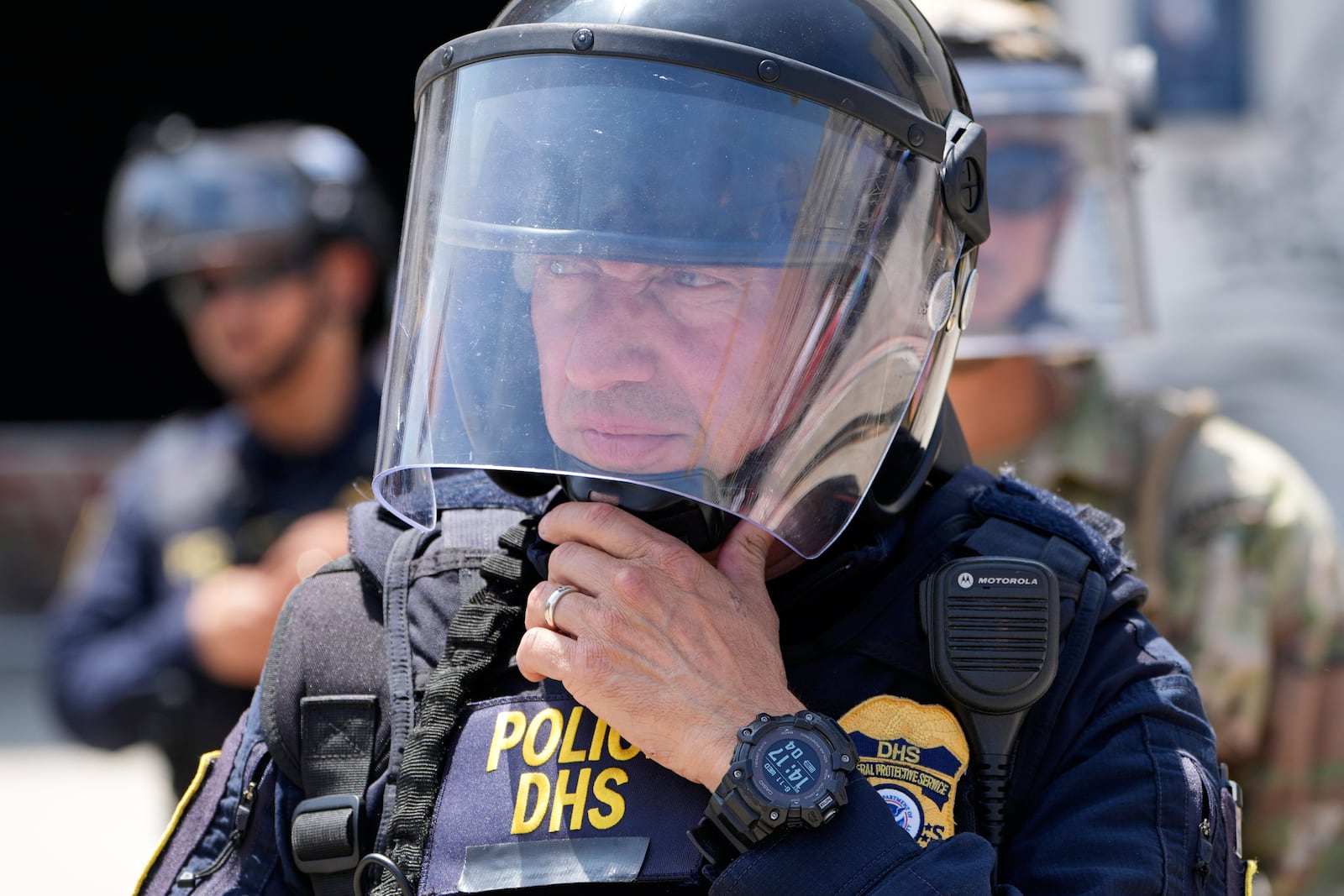National Guard and DHS police stand guard outside the Metropolitan Detention Center, Wednesday, June 11, 2025, in Los Angeles. (AP Photo/Damian Dovarganes)