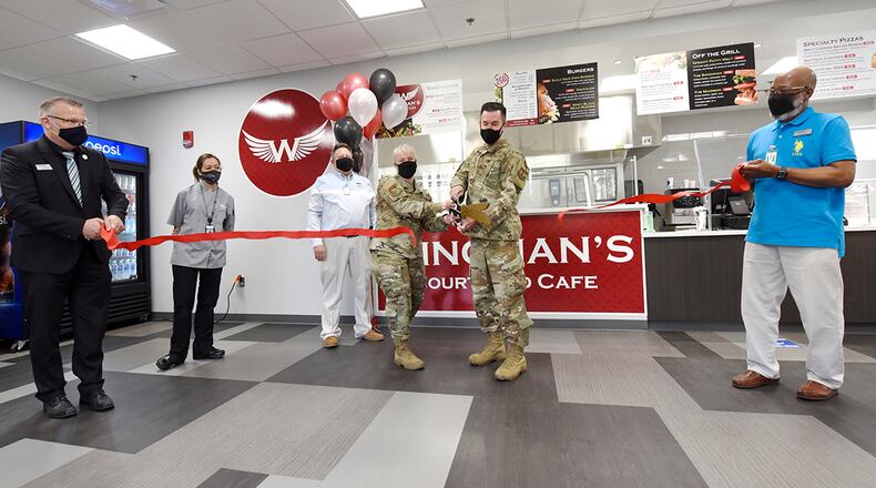 Col. Tracy Hunter (left), interim director of the Air Force Research Laboratory’s Sensors Directorate, and Col. Paul Burger, 88th Mission Support Group commander, cut the ribbon April 6 to open Wingman’s Courtyard Café inside Bldg. 620 on Area B at Wright-Patterson Air Force Base. The opening of Wingman’s was delayed nearly a year due to COVID-19 restrictions. U.S. AIR FORCE PHOTO/TY GREENLEES