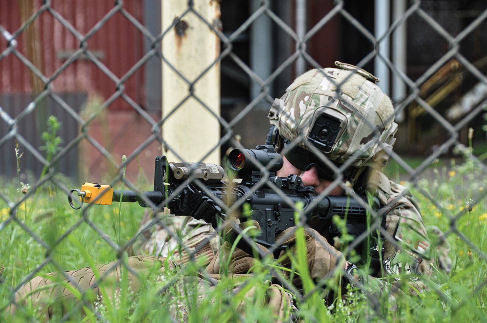 Staff Sgt. Blake Bethel, 445th Security Forces Squadron fire team leader, returns fire with an M4 carbine against a mock insurgency group attacking a decommissioned power plant June 9 in rural West Virginia as part of a training event. U.S. AIR FORCE PHOTO/CAPT. RACHEL INGRAM