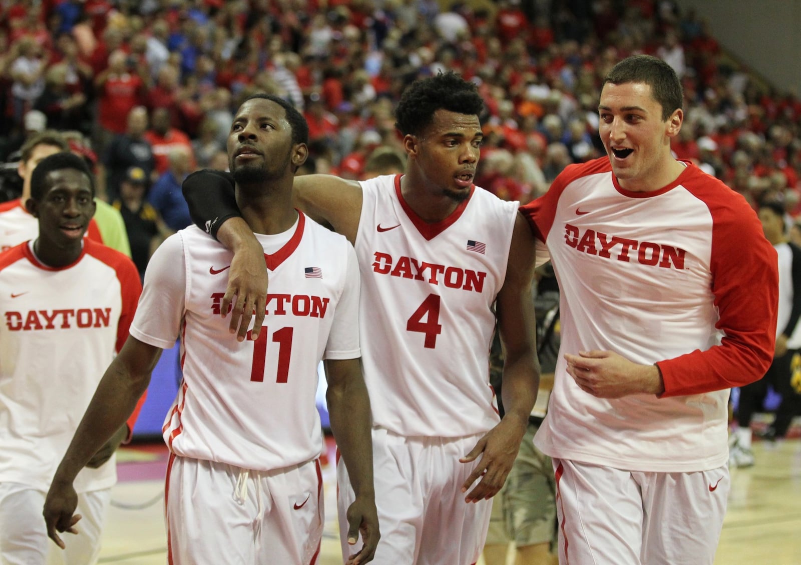 Dayton’s Scoochie Smith, left, Charles Cooke, center, and Bobby Wehrli leave the court after a victory against Iowa in the first round of the AdvoCare Invitational on Thursday, Nov. 26, 2015, at the HP Field House in Orlando, Fla. David Jablonski/Staff