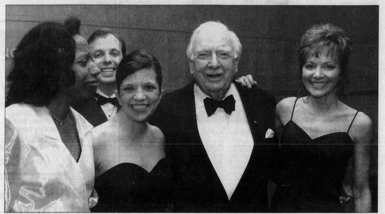 Legendary news anchor Walter Cronkite was master of ceremonies at the opening of the Schuster Center. Here he poses with staff members from the center. DAYTON DAILY NEWS ARCHIVES.