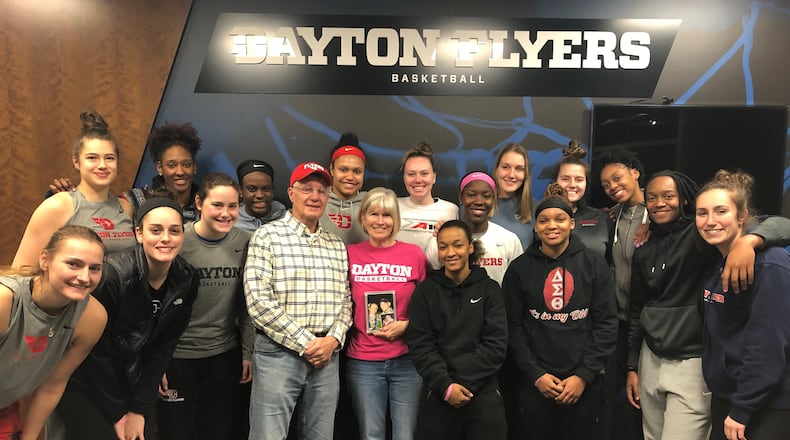 Donny and Pam Fortener surrounded by last season's Dayton Flyers women's team. CONTRIBUTED
