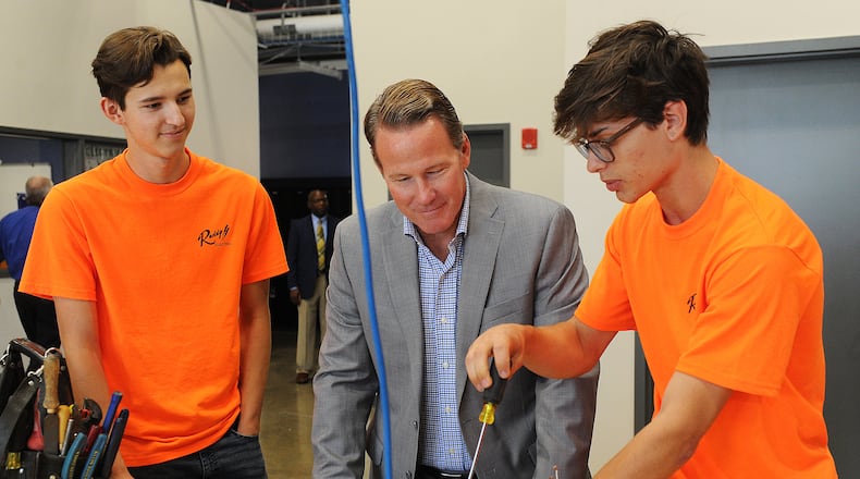 Lt. Governor John Husted visited the Greene County CTC Thursday, Aug. 5, 2021. CTC students, Gabriel Morrison, left and Josh McFall, demonstrates some of the electrical skills they have learned at the center. MARSHALL GORBY\STAFF
