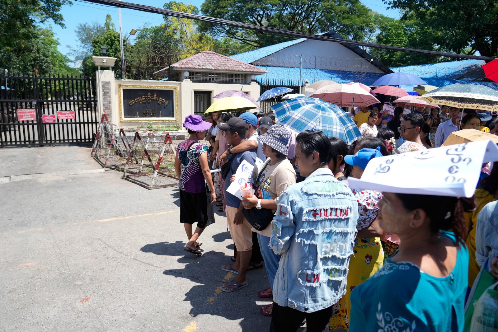 Family members and colleagues wait to welcome released prisoners outside the main gate of Insein prison as the head of Myanmar’s military government granted amnesty to thousands of prisoners to mark the country's traditional New Year Thursday, April 17, 2025, in Yangon, Myanmar. (AP Photo/Thein Zaw)