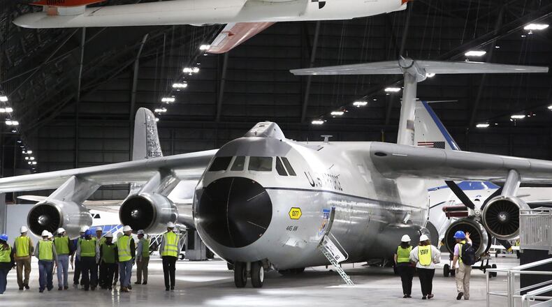 The Lockheed C-141 Starlifter nicknamed the Hanoi Taxi is known for returning the first group of POWs from Vietnam. The huge cargo jet continued in service with this original paint scheme into 2006 when it was retired to the National Museum of the United States Air Force. The Hanoi Taxi is now in the fourth building. Above the C-141 is the Boeing YQM-94A Compass Cope B. a remotely piloted vehicle tested in the 1970s as a long-endurance reconnaissance aircraft. TY GREENLEES / STAFF