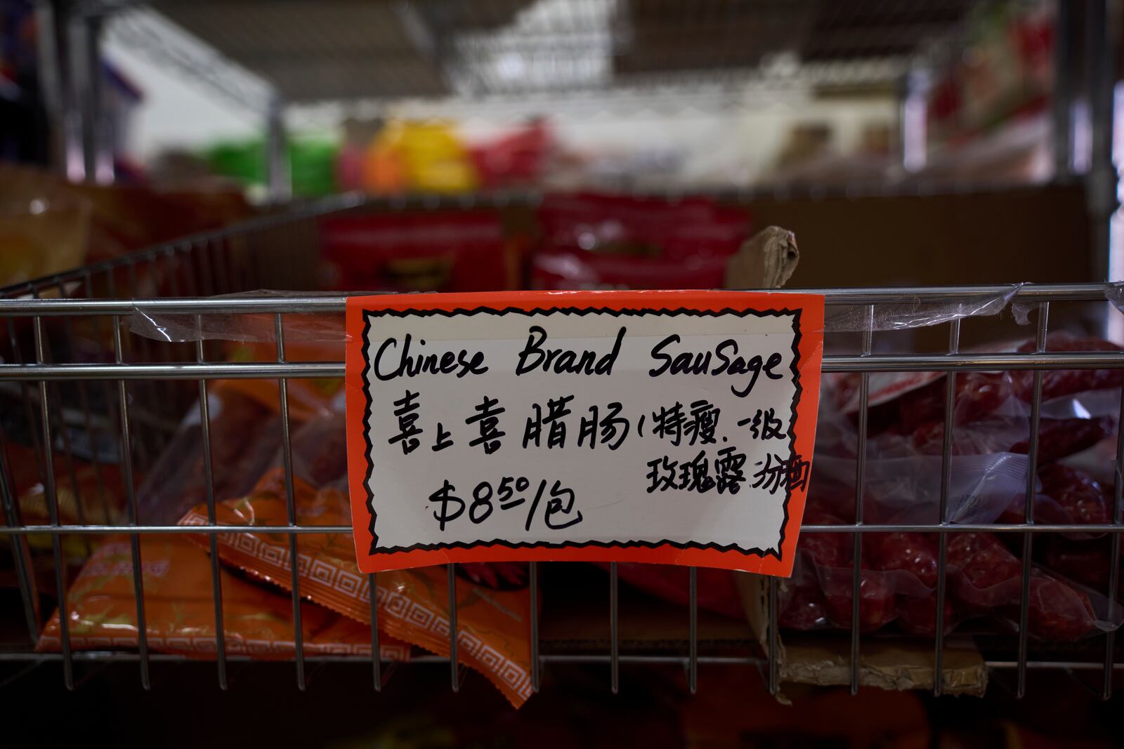A handwritten price tag for sausage imported from China is seen at a grocery market in the Chinatown neighborhood of Los Angeles, Friday, April 11, 2025. (AP Photo/Jae C. Hong)