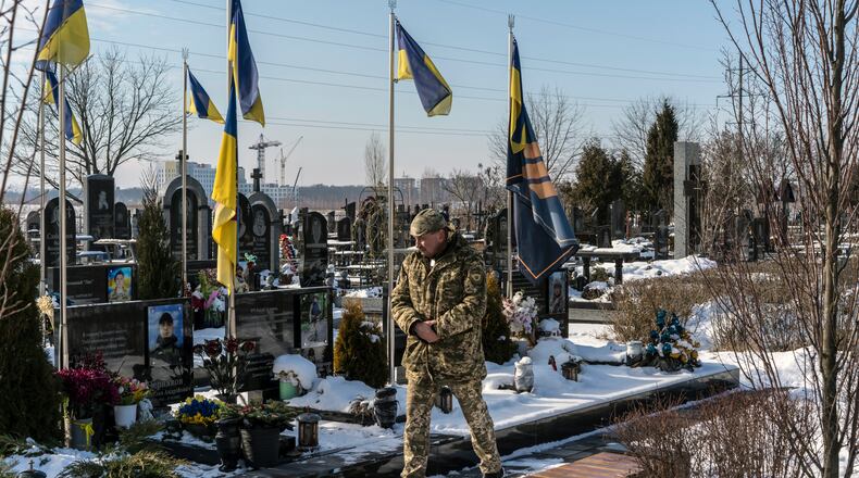 Andrii Pobihai, a retired company commander, at the military cemetery in Bucha, Ukraine, on Wednesday, Feb. 19, 2025. “The best guys are dying,” he says. (Brendan Hoffman/The New York Times)