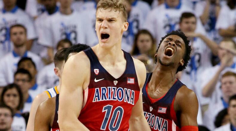 Lauri Markkanen (10) celebrates with Arizona teammate Kobi Simmons after a dunk against UCLA on January 21, 2017, at Pauley Pavilion in Los Angeles. (Luis Sinco/Los Angeles Times/TNS)