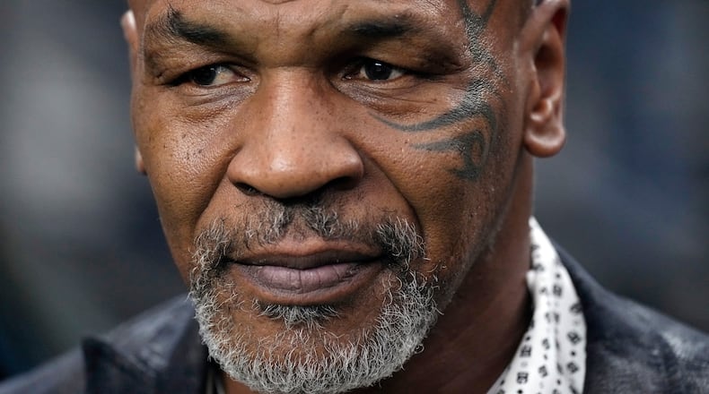FILE - Former heavyweight boxing champion Mike Tyson stands on the field before an NFL football game between the Las Vegas Raiders and the Pittsburgh Steelers, Sept. 24, 2023, in Las Vegas. (AP Photo/Mark J. Terrill, File)