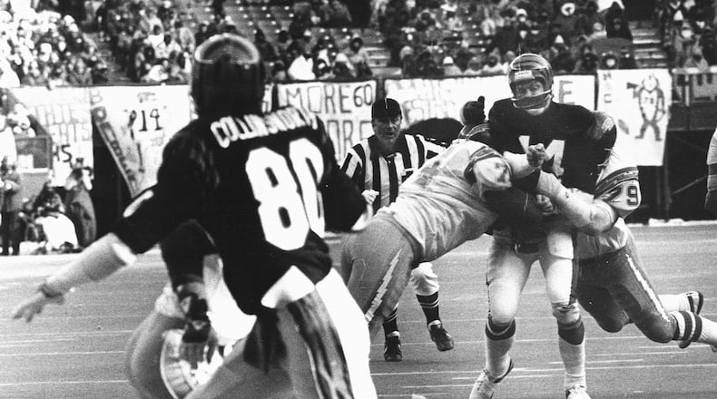Ken Anderson gets hit twice while connecting with Cris Collinsworth during a 1992 game against the San Diego Chargers. SKIP PETERSON / STAFF