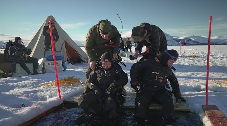 Ruari Buijs, a marine biology and oceanography student, right, and Caroline Chen, a scientific diver and research assistant, prepare to dive during a Polar Scientific Diving class in Kilpisjärvi, March 15, 2026. (AP Photo/Kostya Manenkov)