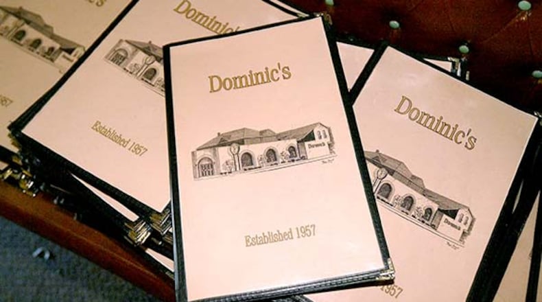 Dozens of menus were stacked up to be sold during an auction at Dominic's, the landmark restaurant at 1066 S. Main St. in Dayton. FILE