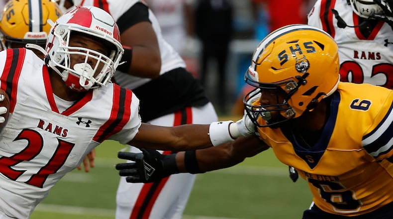 Trotwood's Quintin Petty tries to avoid a tackle by Springfield's Taj Powell. BILL LACKEY/STAFF