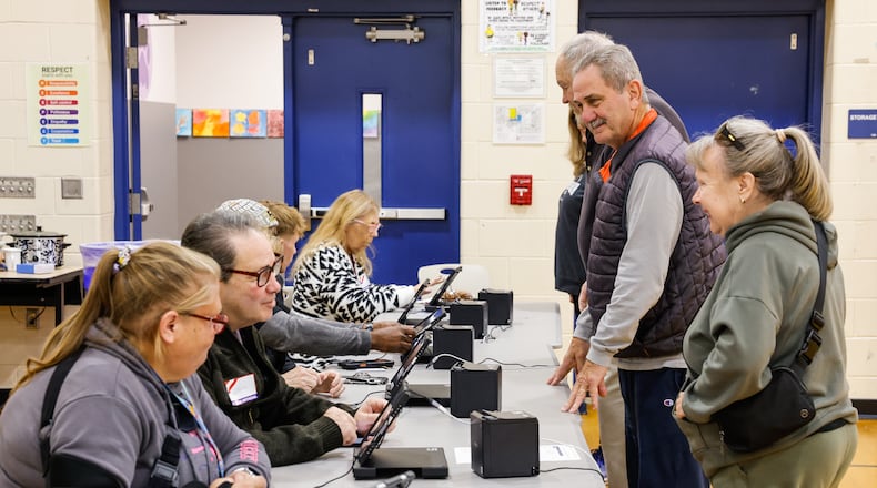 Poll workers check in voters at the polling location in the gymnasium of Creekview Elementary School Tuesday, Nov. 4, 2025 in Middletown. NICK GRAHAM/STAFF