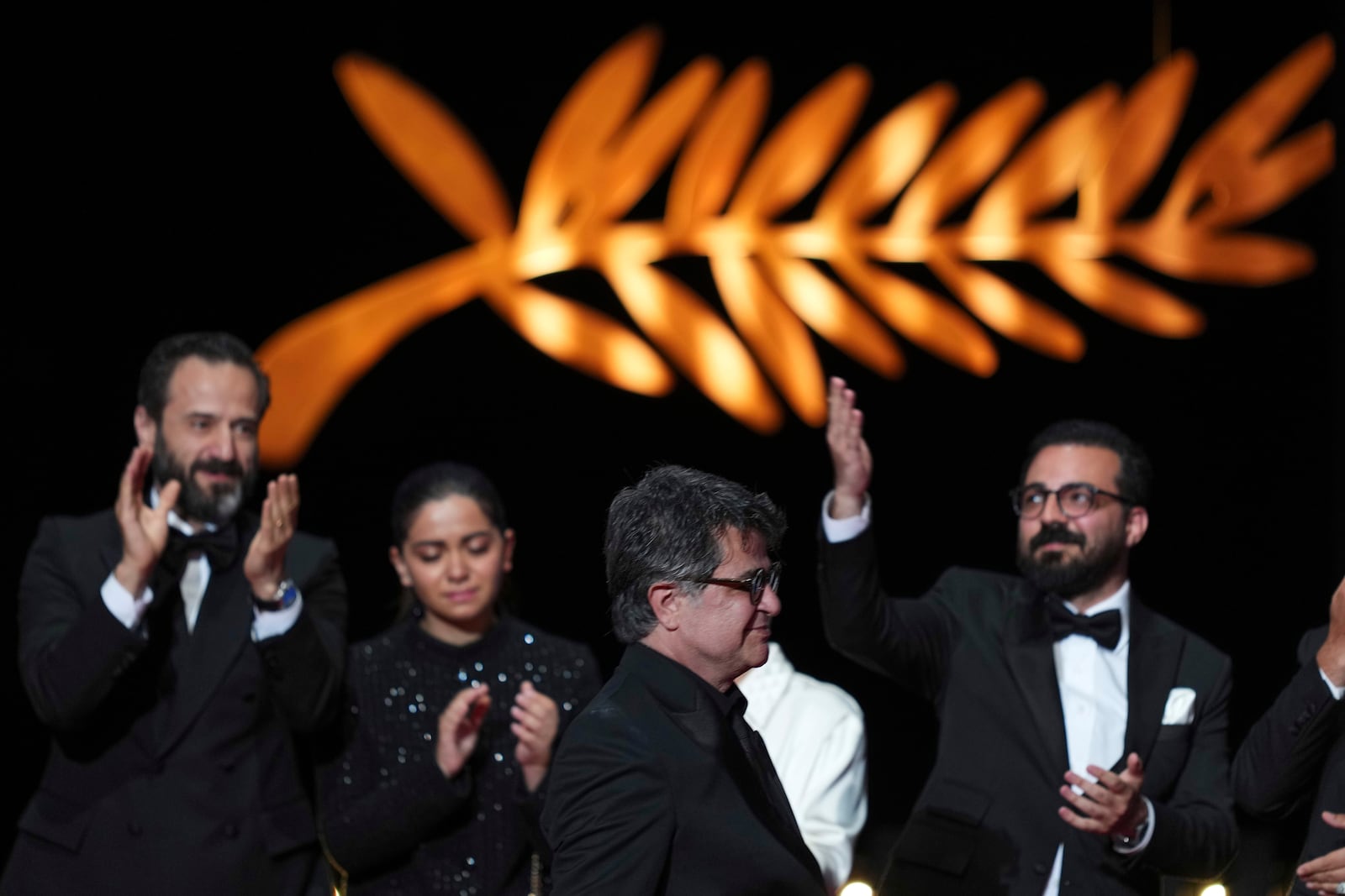 Director Jafar Panahi, front, accepts the Palme d'Or for the film 'It Was Just an Accident', during the awards ceremony of the 78th international film festival, Cannes, southern France, Saturday, May 24, 2025. (Photo by Lewis Joly/Invision/AP)