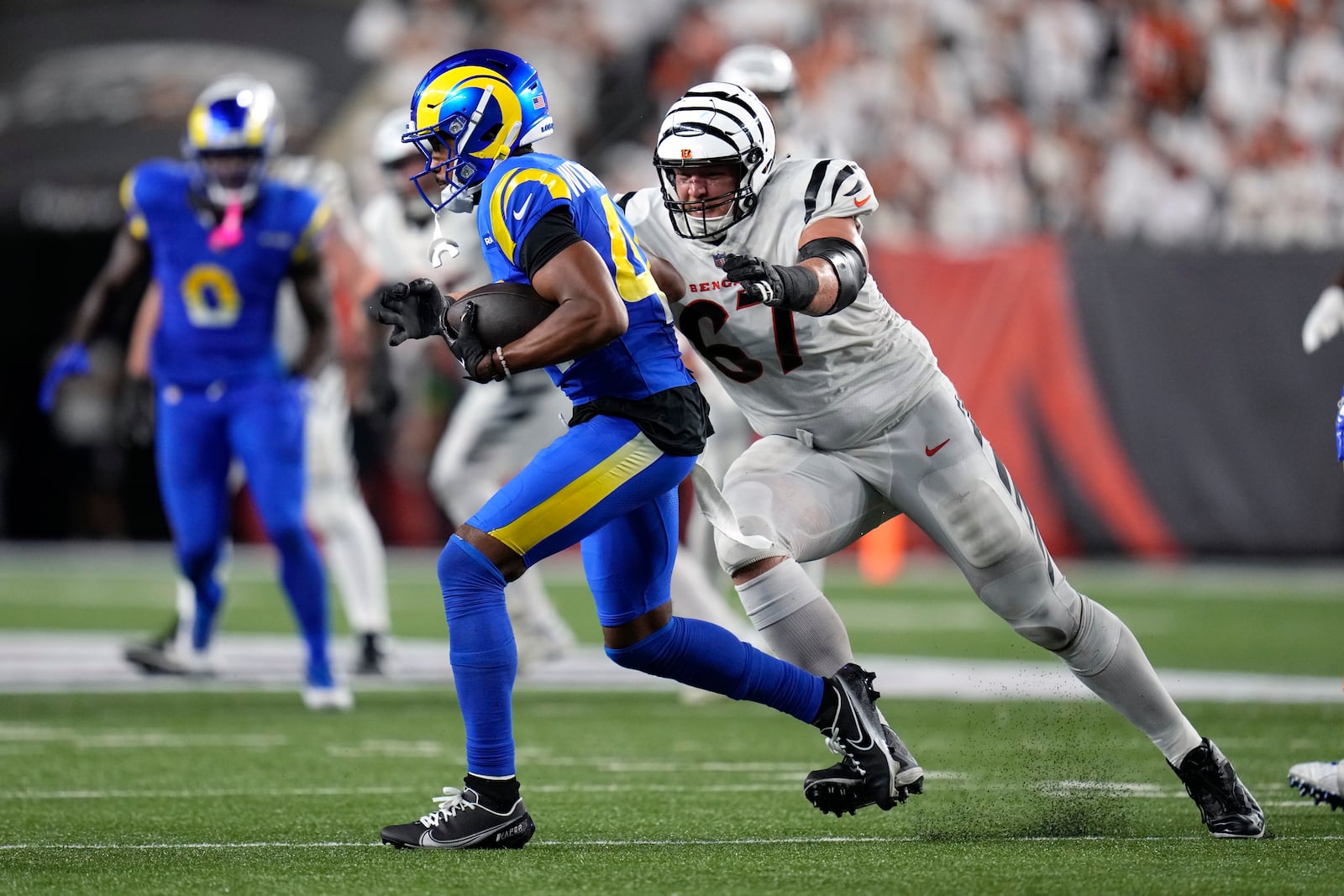 Los Angeles Rams defensive back Ahkello Witherspoon (44) runs with the ball after intercepting a pass as Cincinnati Bengals guard Cordell Volson (67) defends during the second half of an NFL football game Monday, Sept. 25, 2023, in Cincinnati. (AP Photo/Michael Conroy)