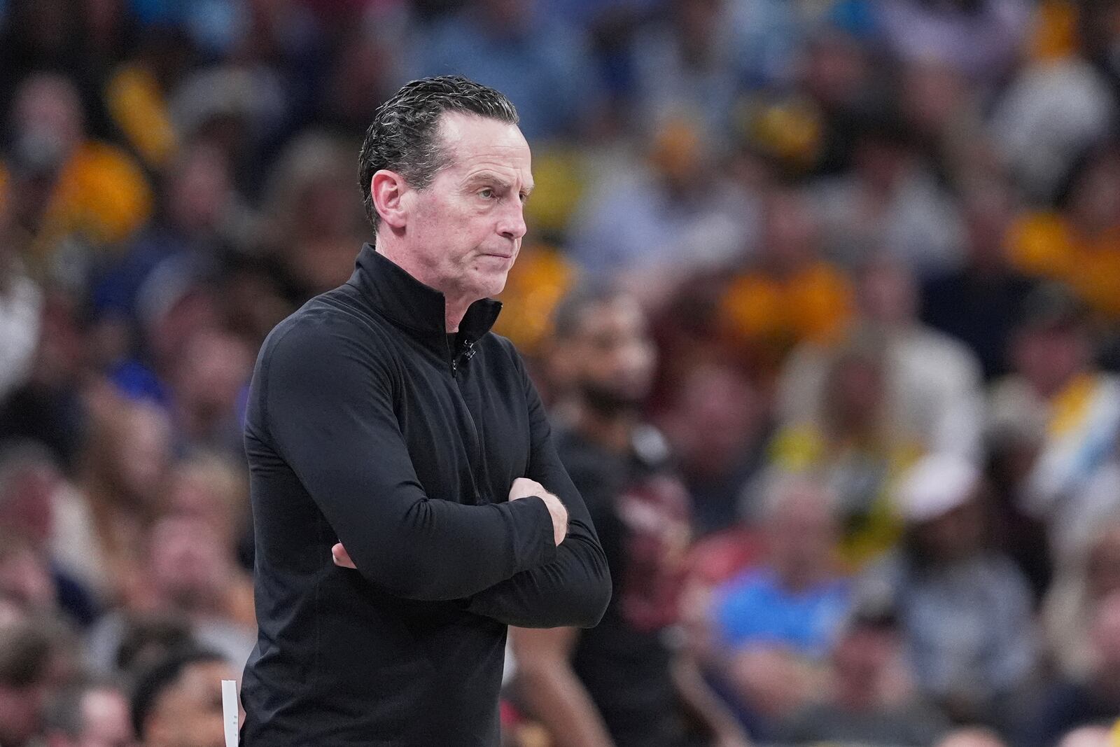 Cleveland Cavaliers head coach Kenny Atkinson watches from the bench in the first half of Game 4 against the Indiana Pacers in the Eastern Conference semifinals of the NBA basketball playoffs in Indianapolis, Sunday, May 11, 2025. (AP Photo/Michael Conroy)