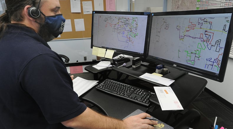 Henry Muller, dispatcher for Kettering schools' busing operation, looks over routing information, Wednesday, Jan. 20, 2021. MARSHALL GORBY\STAFF