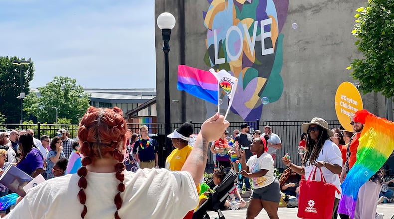 Hundreds gathered along the route of the Dayton Pride parade Saturday morning. AIMEE HANCOCK/STAFF