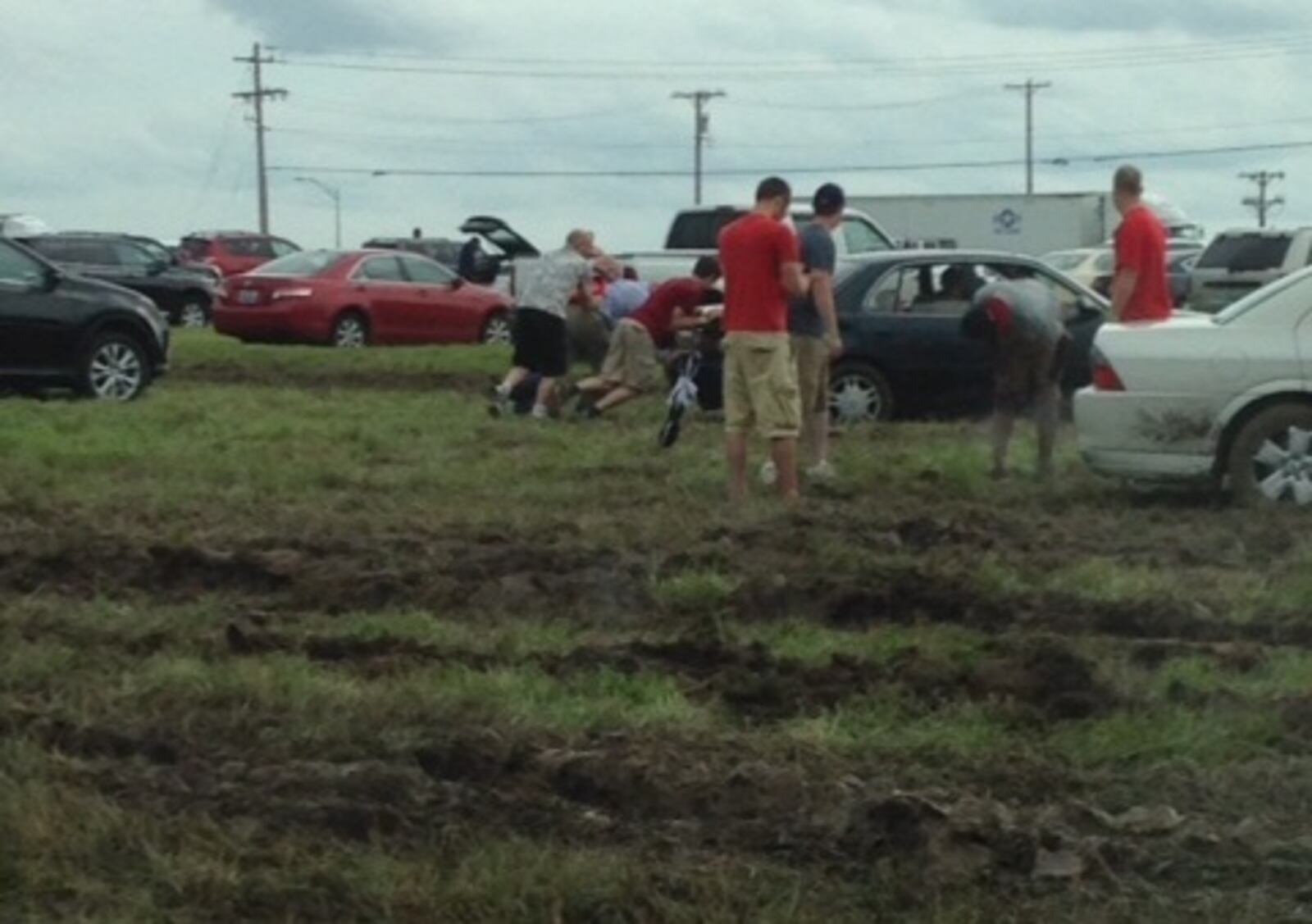 A 2015 photo of Dayton Air Show spectators having to walk through 4-inch deep puddles and mud near show parking areas. JANEL SKERL / CONTRIBUTED)
