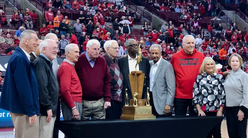 Bob Knight (maroon sweater), Jerry Lucas (third from right) and the rest of the Buckeyes pose with the 1960 national championship trophy at Ohio State in 2020. Marcus Hartman/STAFF