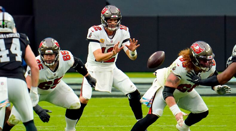 FILE - In this Oct. 25, 2020, file photo, Tampa Bay Buccaneers quarterback Tom Brady (12) receives the ball from center Ryan Jensen (66) during the first half of the team's NFL football game against the Las Vegas Raiders in Las Vegas. “It didn’t take too long, really,” Jensen said of building a rapport with Brady. “We both kind of have a fiery spirit and, you know, I think that has helped us quite a bit, getting to know each other and knowing what we’re about.”  (AP Photo/Jeff Bottari, File)