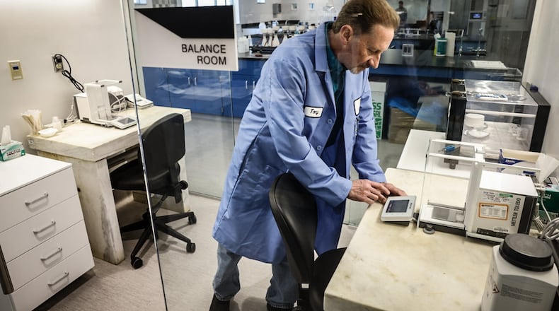 Montgomery County Environmental chemist Tony Miley uses a scale to weigh chemicals at the new Montgomery County Environmental Service lab. The new multi-million dollar lab located in the basement of park garage adjacent to the Montgomery County administration building. JIM NOELKER/STAFF