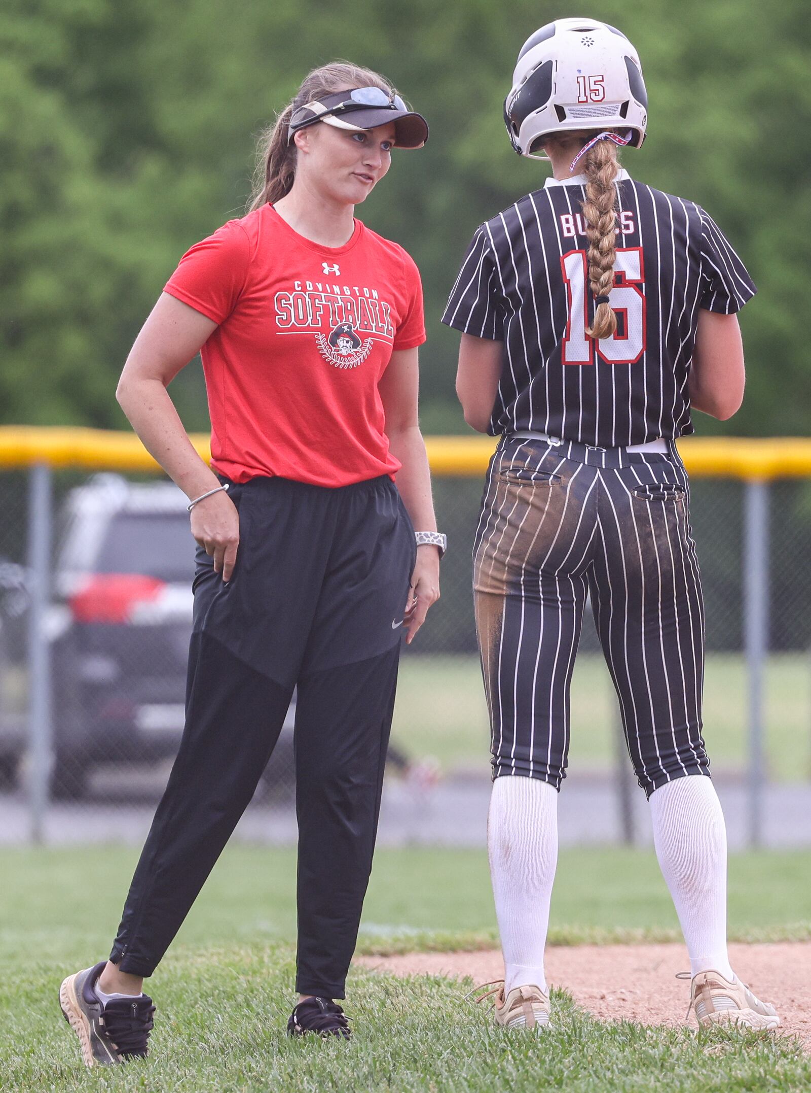 Covington coach Brooke Gostomsky-Menker talks to Ava Hartwig during a Division VII regional semifinal against Ansonia on Wednesday at Northmont High School. BRYANT BILLING / STAFF