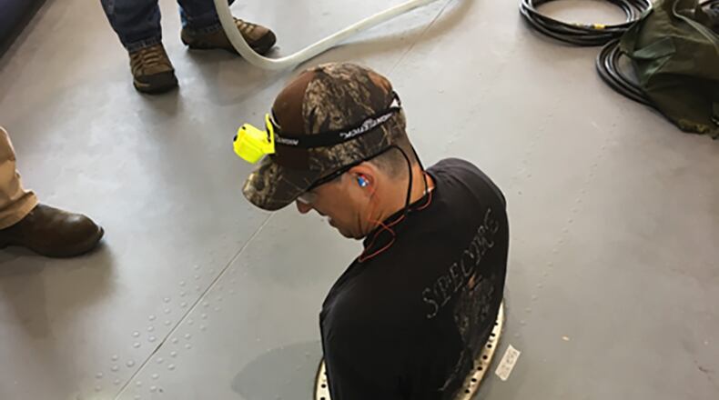 A maintainer uses the Confined Space Monitoring System in the wing of a C-17 aircraft. The Air Force Research Laboratory partnered with Dayton, Ohio-based small business Sentinel Occupational Safety Inc. to refine and market this technology as an added layer of safety for maintenance crews. U.S. AIR FORCE PHOTO/JENNIFER TRIBBLE