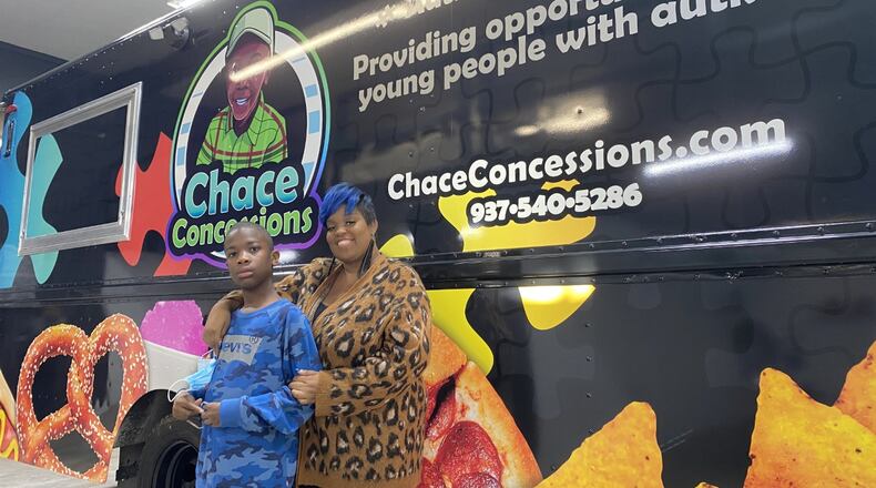 Dayton entrepreneur Tae Winston (right) gifted a food truck to her 11-year-old son, Chace, who has autism. The truck, which was presented to the boy at Performance Wraps in Miamisburg Monday, Dec. 13, 2021. It will employ people with autism, raising awareness of the developmental disorder and raising funds for the Dayton Autism Society. ERIC SCHWARTZBERG/STAFF