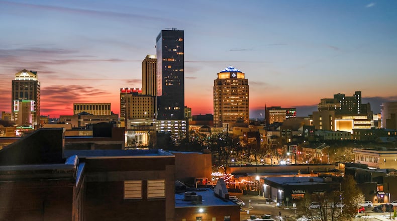 The Dayton skyline is surrounded by a colorful blue and pink dusk sky on Friday, Dec. 5, 2025. JOSEPH COOKE/STAFF