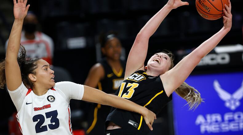 VCU's Chloe Bloom, right, reaches for rebound against Dayton's Mariah Perez during an NCAA college basketball game in the semifinal round of the Atlantic 10 conference tournament Saturday, March 13, 2021, in Richmond, Va. (Alexa Welch Edlund/Richmond Times-Dispatch via AP)