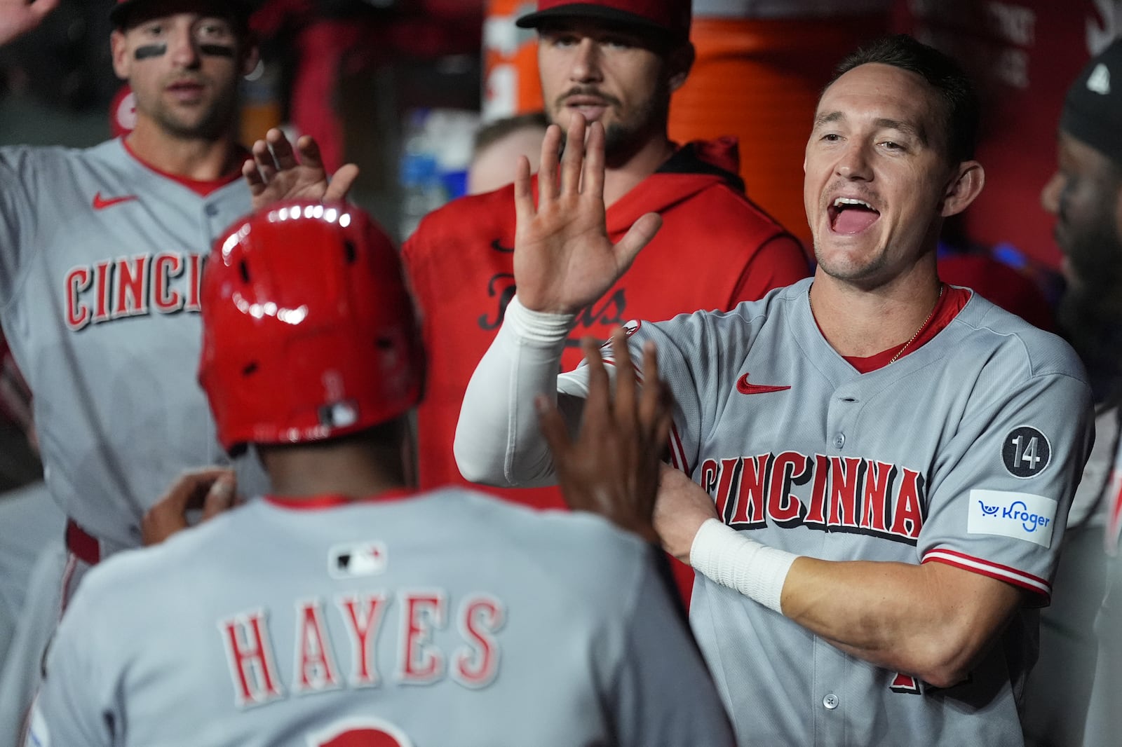 Cincinnati Reds' Ke'Bryan Hayes, left, celebrates his run scored against the Arizona Diamondbacks with Reds' Austin Hays, right, during the second inning of a baseball game Friday, Aug. 22, 2025, in Phoenix. (AP Photo/Ross D. Franklin)