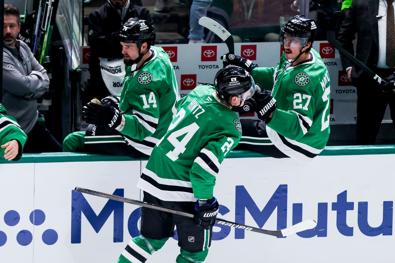 Dallas Stars center Roope Hintz (24) celebrates after scoring with Jamie Benn (14) and Mason Marchment (27) during a first-round NHL hockey playoff game against the Colorado Avalanche in Dallas, Saturday, April 19, 2025. (AP Photo/Gareth Patterson)