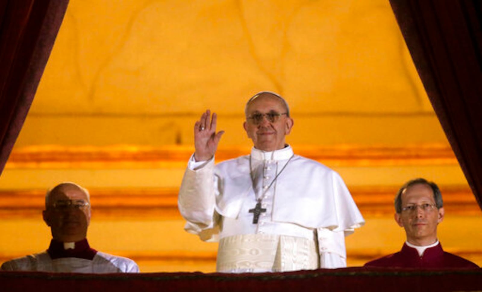 FILE - Argentine Cardinal Jorge Bergoglio, who chose the name of Pope Francis, waves to the crowd from the central balcony of St. Peter's Basilica after being elected 266th pontiff of the Roman Catholic Church, at the Vatican, Wednesday, March 13, 2013. (AP Photo/Gregorio Borgia, file)