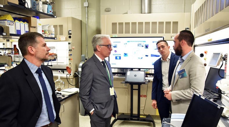 Ohio State University futurist Dr. David Staley talks with researchers in the chemistry foundry lab. Pictured from left to right are Dr. Russell Kurtz, Dr. David Staley, Dr. Luke Baldwin and Jordan Kaiser. (U.S. Air Force photo/Spencer Deer)