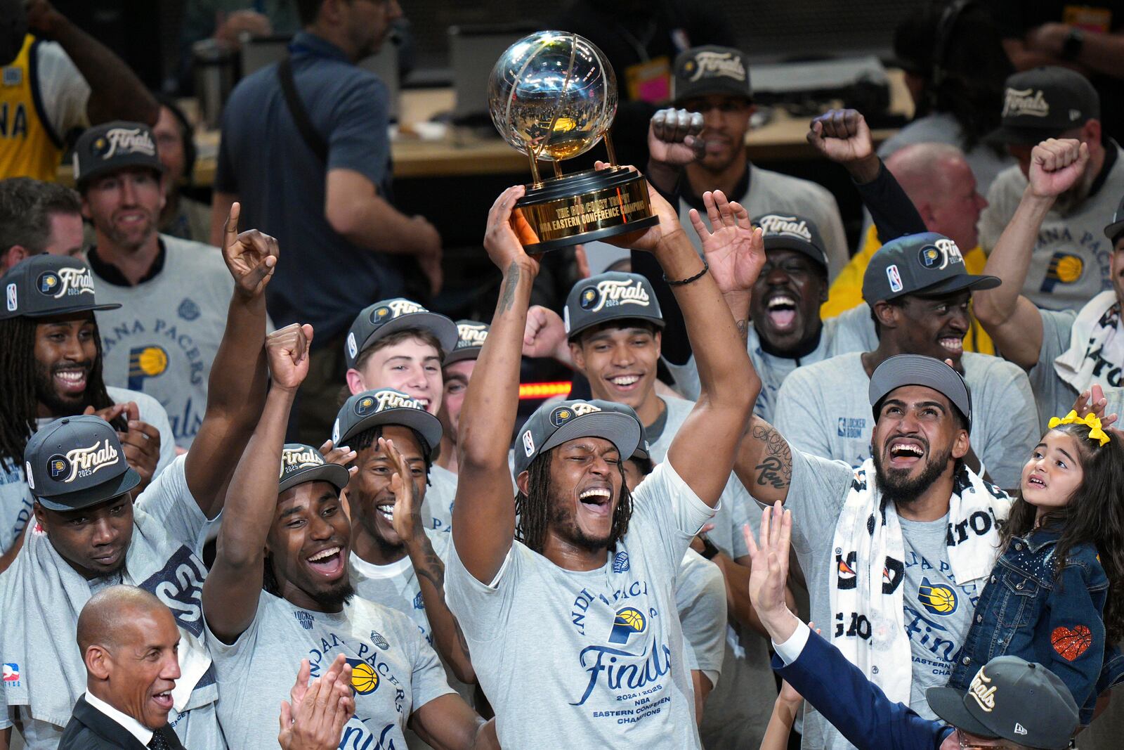 Indiana Pacers center Myles Turner holds the trophy as players celebrate after winning Game 6 of the Eastern Conference finals of the NBA basketball playoffs against the New York Knicks in Indianapolis, Saturday, May 31, 2025. (AP Photo/AJ Mast)