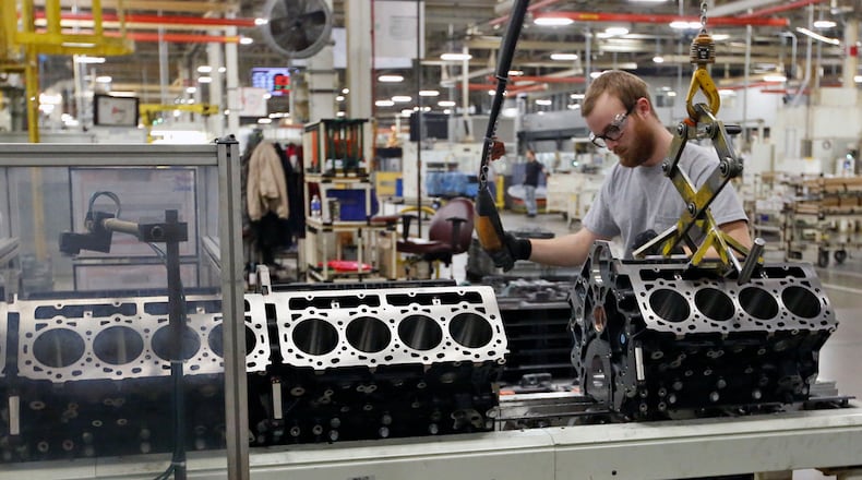 Worker Mat Gray moves Duramax Diesel engine blocks to the DMAX assembly line in Moraine. TY GREENLEES / STAFF
