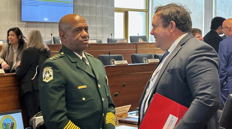 Mecklenburg County Sheriff Garry McFadden, left, speaks with state Rep. Eric Ager, D-Buncombe, during a break in the North Carolina House Select Committee on Oversight and Reform meeting at the Legislative Building in Raleigh, N.C., Monday, Feb. 9, 2026 (AP Photo/Gary D. Robertson)