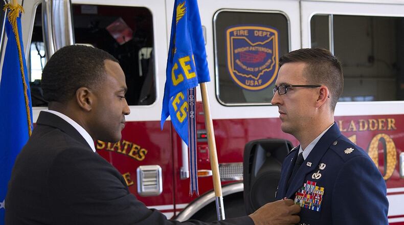 Amir Mott, 88th Civil Engineering Group acting director, pins the Meritorious Service Medal on Lt. Col. Tyler Johnson May 26, 2020, during a change of command ceremony in which Johnson relinquished command of the 788th Civil Engineering Squadron to Maj. Jonathan Polston in the Wright-Patterson Air Force Base, Ohio, Fire Station 1. Johnson spent two years as the 788th CES commander, a time frame including last year’s Memorial Day tornadoes and the current corona pandemic. (U.S. Air Force photo/R.J. Oriez)
