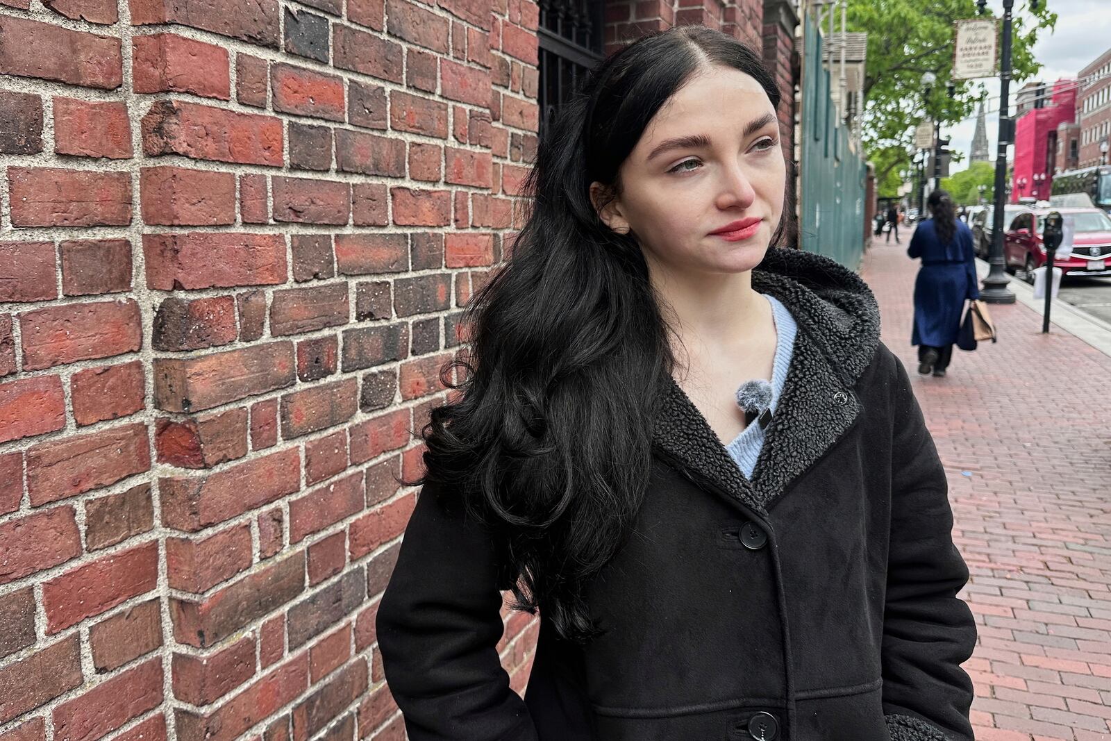 Aleksandra Conevska, a Canadian graduate student studying climate change, speaks about the Trump administration's decision to revoke the school's ability to enroll international students on the Harvard University campus in Cambridge, Mass., on Friday, May 23, 2025. (AP Photo/Michael Casey)