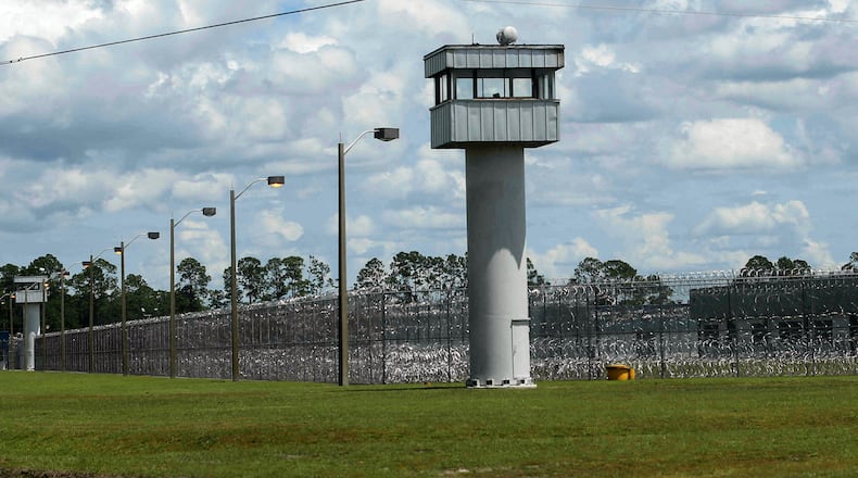 FILE - Fence and towers at the Baker Correctional Institution, Sanderson, Fla., Thursday, Aug. 14, 2025. (AP Photo/Gary McCullough, File)