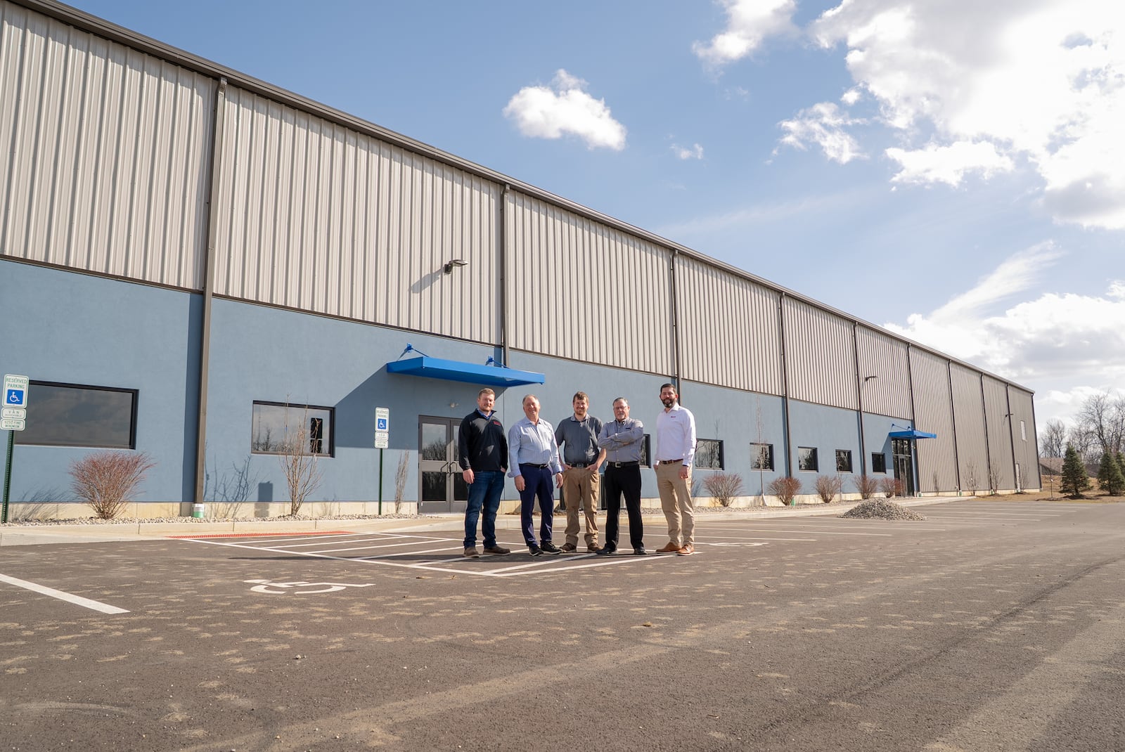 Bruns General Contracting and Belton Foods teams outside of Belton Foods' new $8 million,  73,750-square-foot facility recently completed by Bruns General Contracting at the Englewood Otterbein Industrial Park. CONTRIBUTED