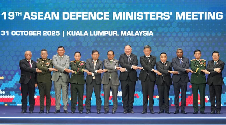 From left, Brunei's Defense Minister Halbi bin Haji Mohd Yussof, Cambodia's Defense Minister Tea Seiha, Indonesia's Defense Minister Sjafrie Sjamsoeddin, Laos' Defense Minister Khamlieng Outhakaisone, Myanmar's Permanent Secretary of the Ministry of Foreign Affairs Aung Kyaw Moe, Malaysia's Defense Minister Mohamed Khaled Nordin, Philippine's Defense Secretary Gilberto Teodoro, Singapore's Defense Minister Chan Chun Sing, Thailand's Defense Minister Natthaphon Narkphanit, East Timor's Defense Minister Donaciano da Costa Gomes, Vietnam's Defense Minister Phan Van Giang, and ASEAN Secretary-General Kao Kim Hourn hold hands as they pose for a group photo during the opening session of the Association of Southeast Asian Nations (ASEAN) Defense Ministers' Meeting in Kuala Lumpur, Malaysia, Friday, Oct. 31, 2025. (AP Photo/Dita Alangkara, Pool)