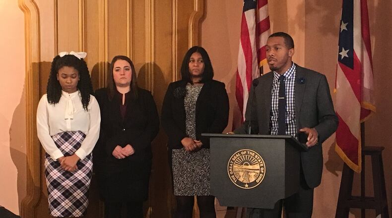 Dayton Early College Academy Chief Academic Officer Dave Taylor tells Ohio Gov. John Kasich about the school’s college prep program. LAURA A. BISCHOFF/PHOTO